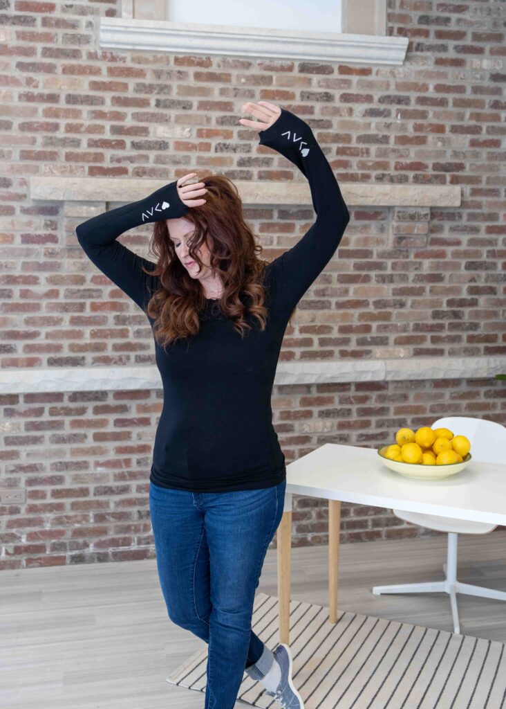 Allison Jorgens posing confidently in front of a brick wall, describing her creative and uplifting branding shoot with Marta Raptis.