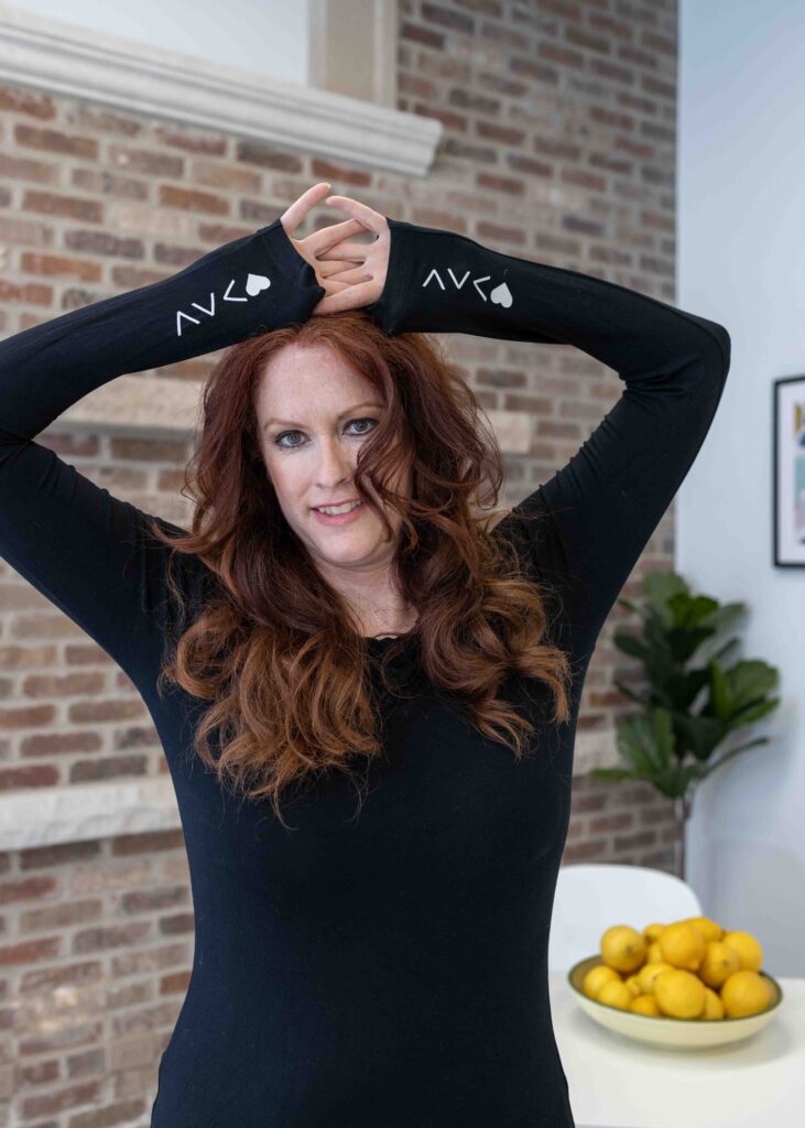 woman holding hands up with lemons in background