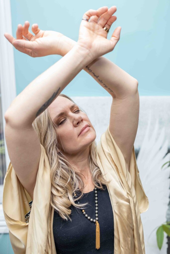 woman holding arms up spiritually