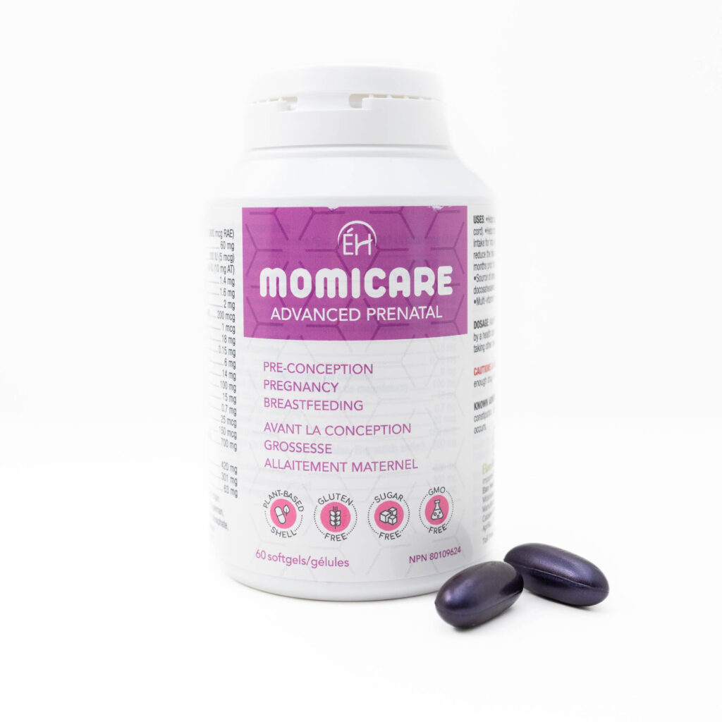 White bottle labeled “Momicare Advanced Prenatal” with purple accents and capsules on a clean white background — photographed by Marta Raptis in Mississauga