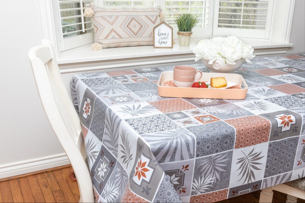 Lifestyle product photo of a breakfast tray on a patterned tablecloth with coffee cup, pastry, and flowers — photographed by Marta Raptis in Mississauga.