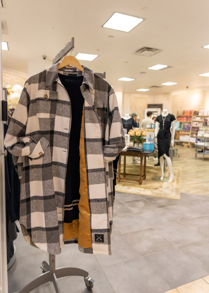 Lifestyle retail photography showing clothing racks and shoppers in a Burlington boutique