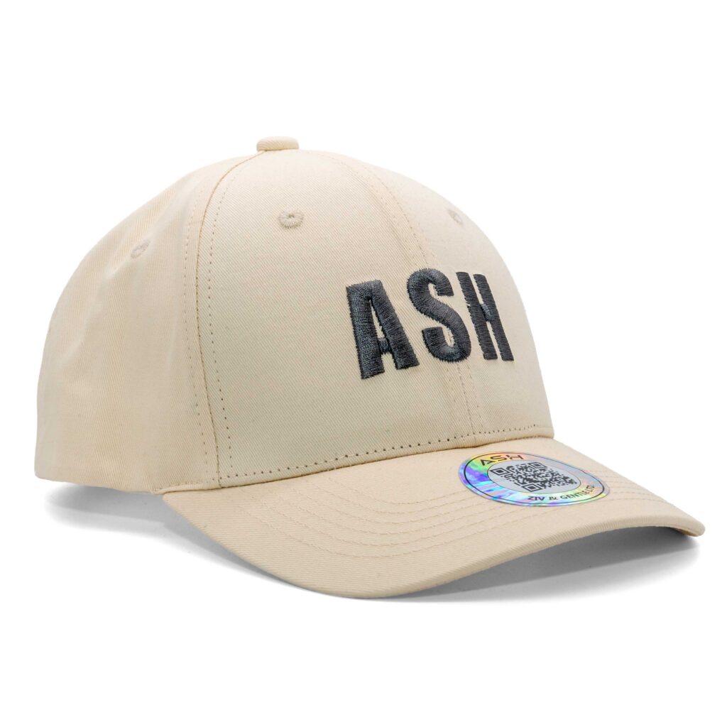 Beige ASH baseball cap photographed on white background, showing embroidered logo on front panel.