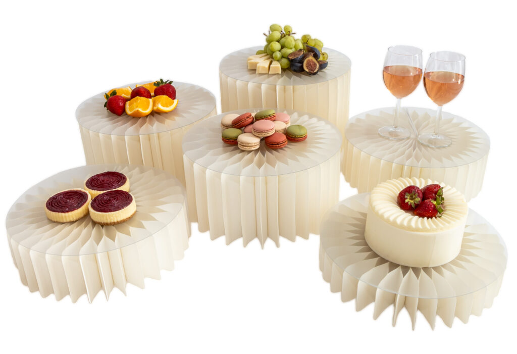 White foldable honeycomb buffet risers with frosted acrylic trays displayed for event décor.