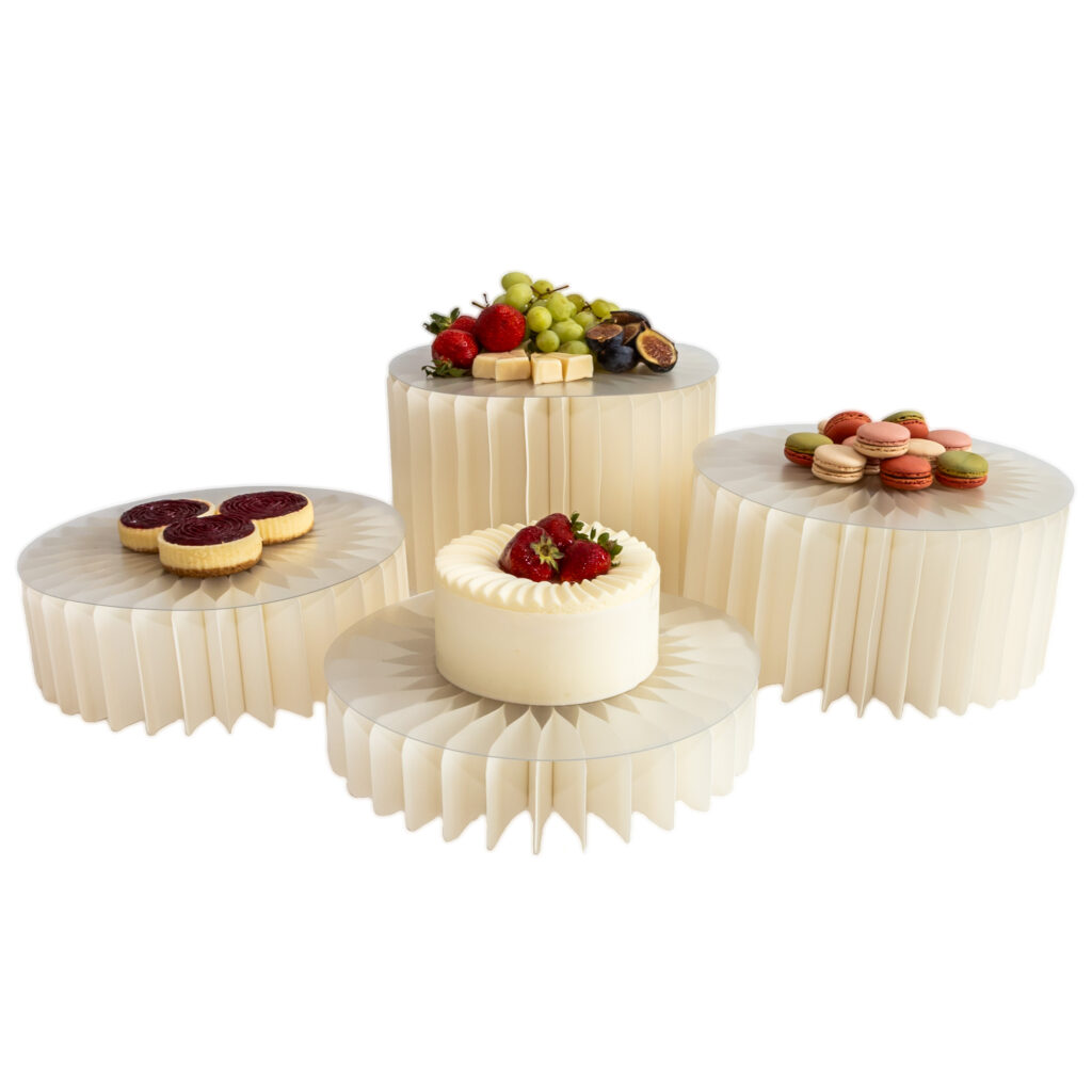 Foldable paper risers with acrylic trays used for wedding and catering table displays.